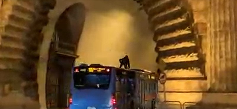 A hooded figure riding on top of a bus was captured on video in Budapest